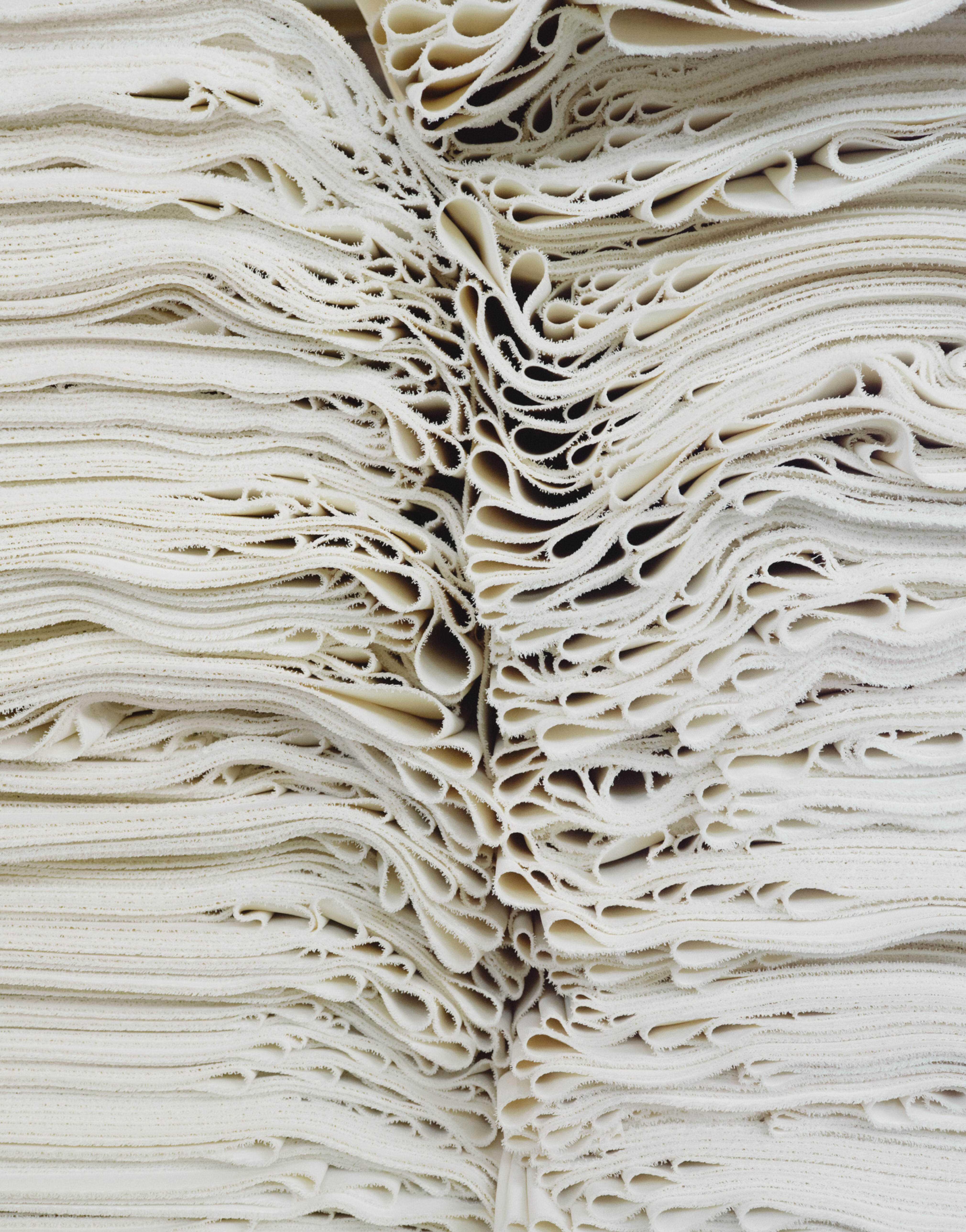 Piled sheets of white fabric