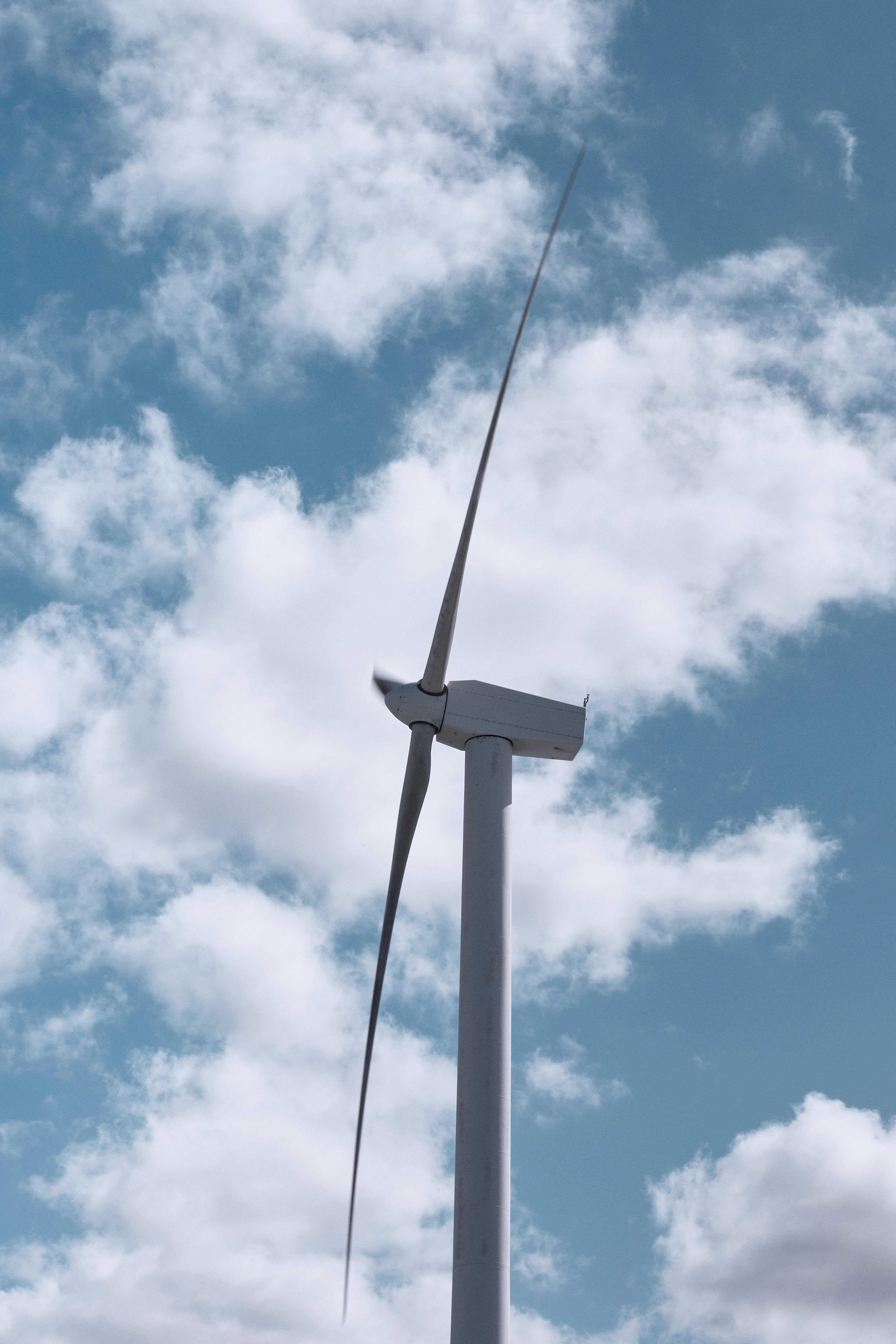 Wind generator against sky backdrop.