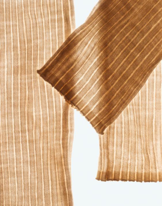 Detail of semi-transparent ribbed fabric in beige.